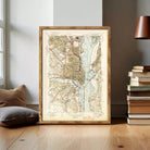 The image is a framed vintage map of the Washington, D.C. area, depicting the city's streets, waterways, and surrounding landscape.