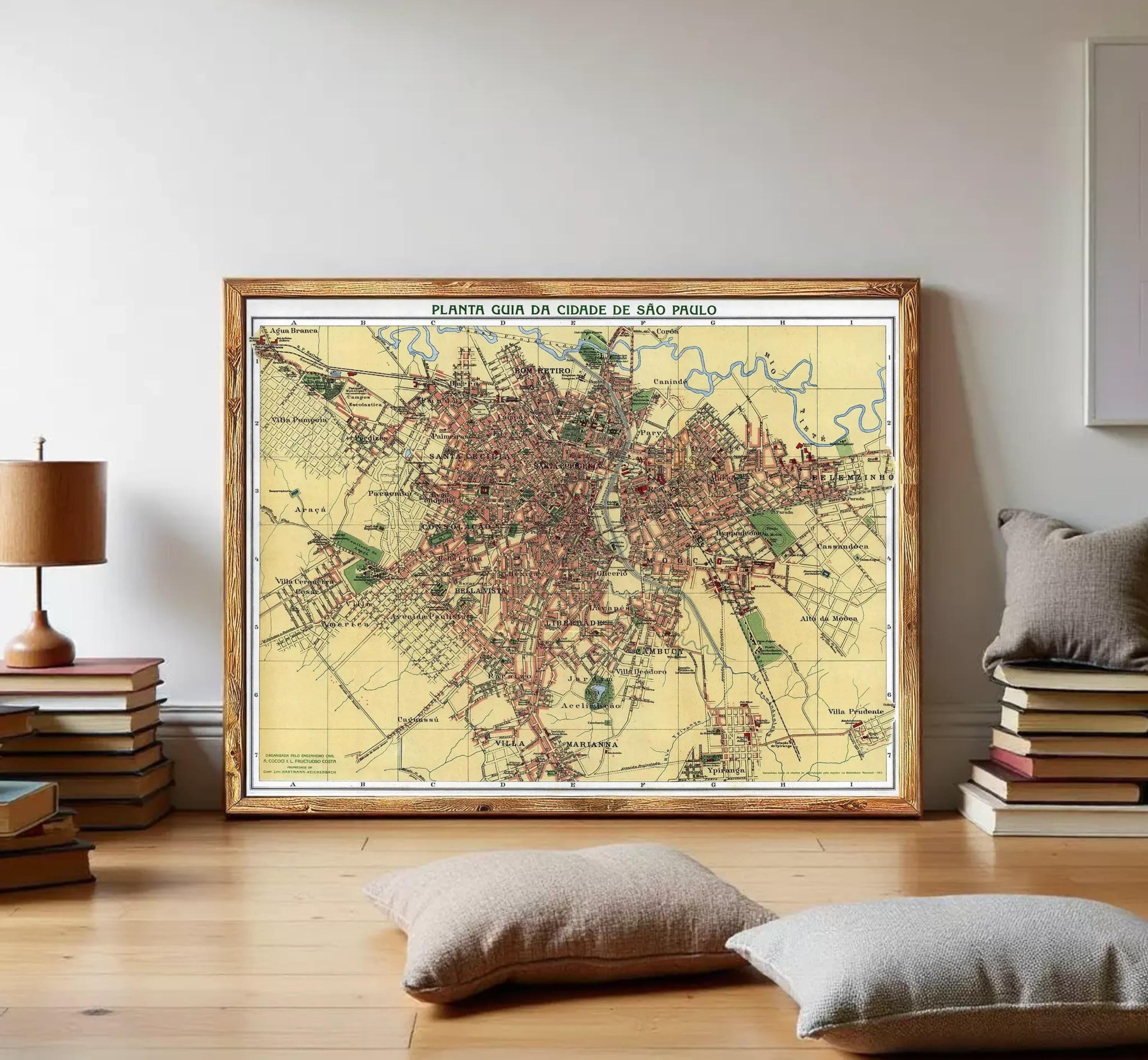 The image is a framed vintage map of a city, likely from the early 20th century, with a wooden frame.