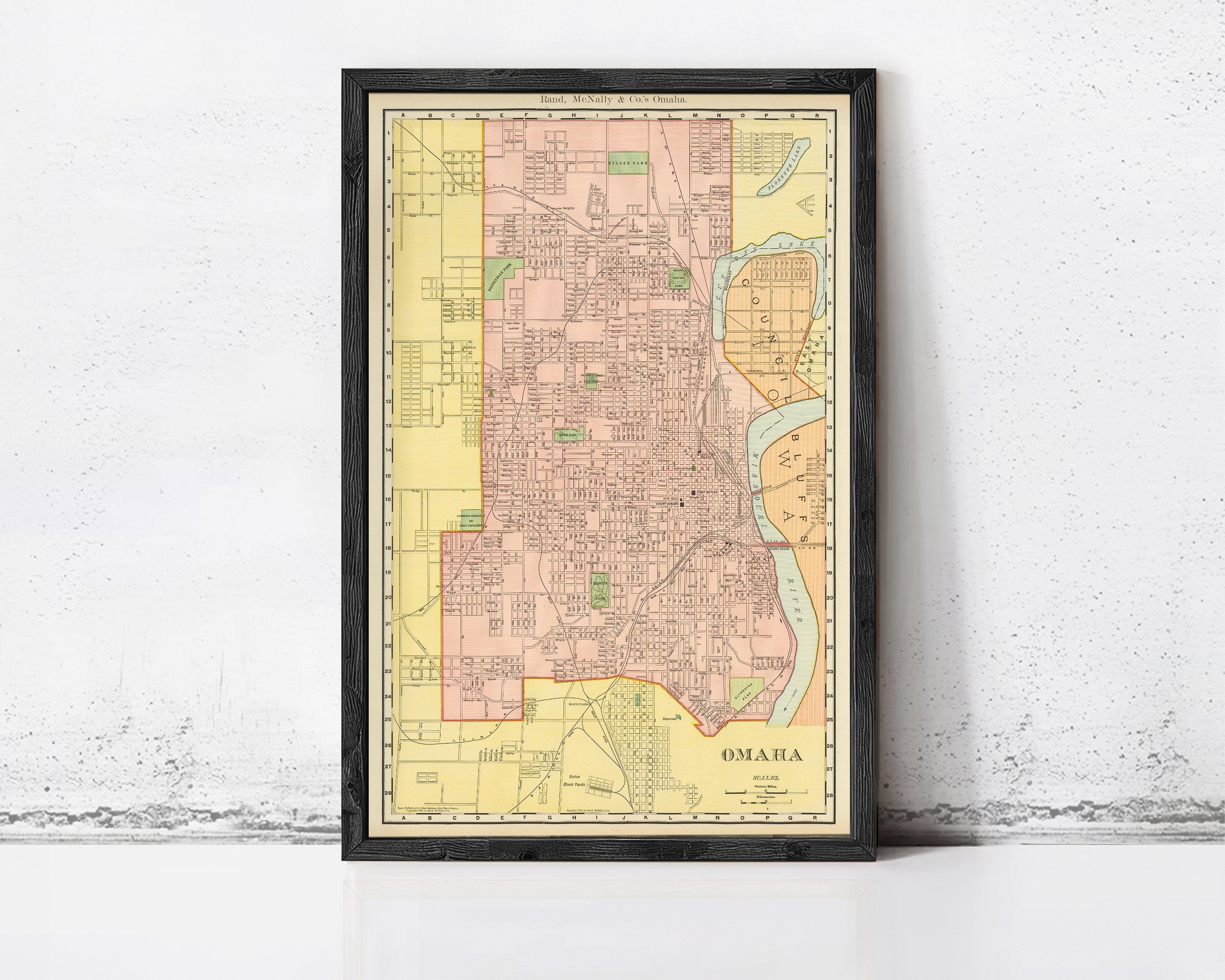 The image is a framed vintage map of Omaha, Nebraska, showing the city's layout and surrounding areas.