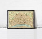 The image is a framed vintage map of a city, depicting streets, landmarks, and other geographical features.