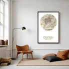 a cozy living room with a wooden chair, a floor lamp, and a framed map of Munich.