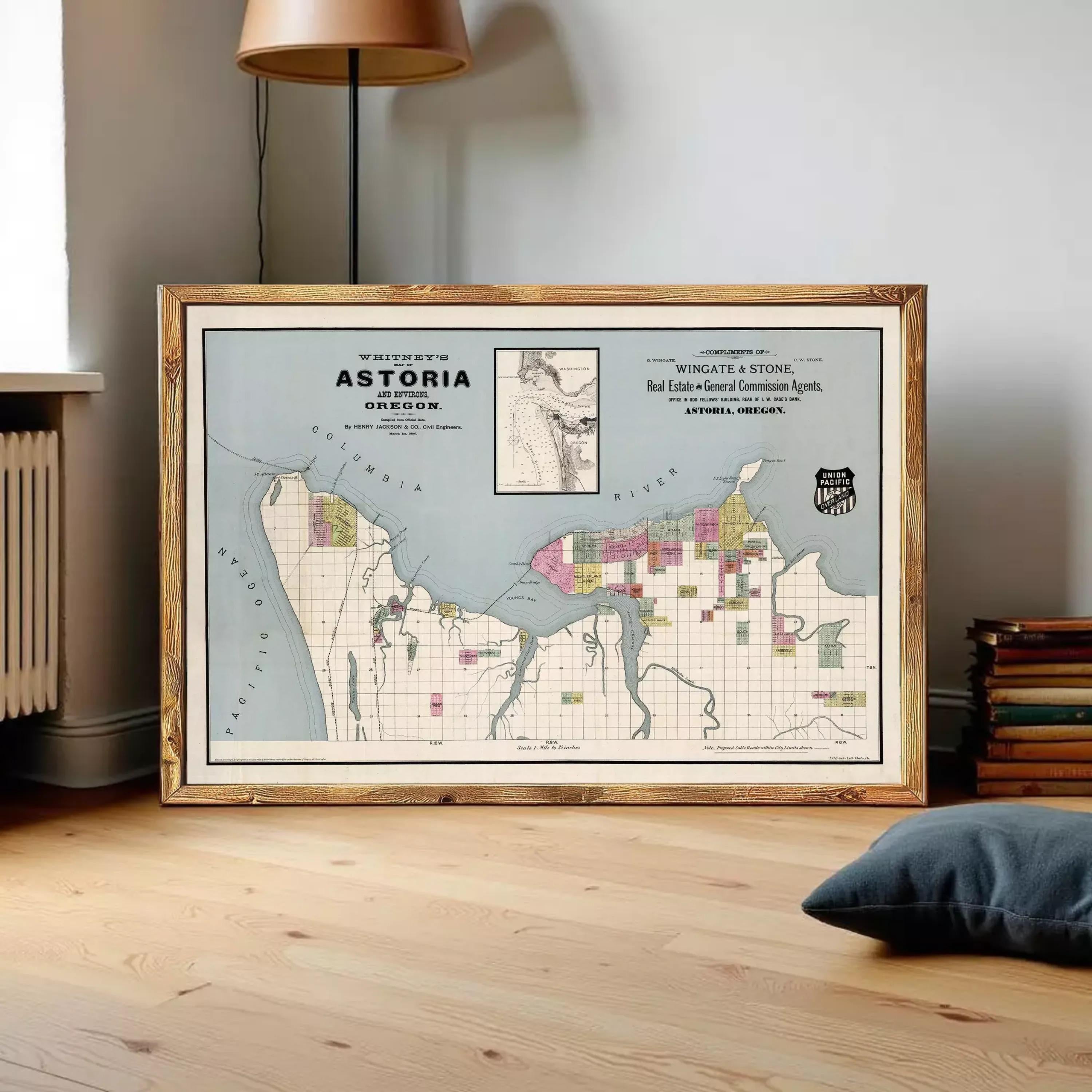 A framed map of Astoria, Oregon, with a vintage style and a wood frame.