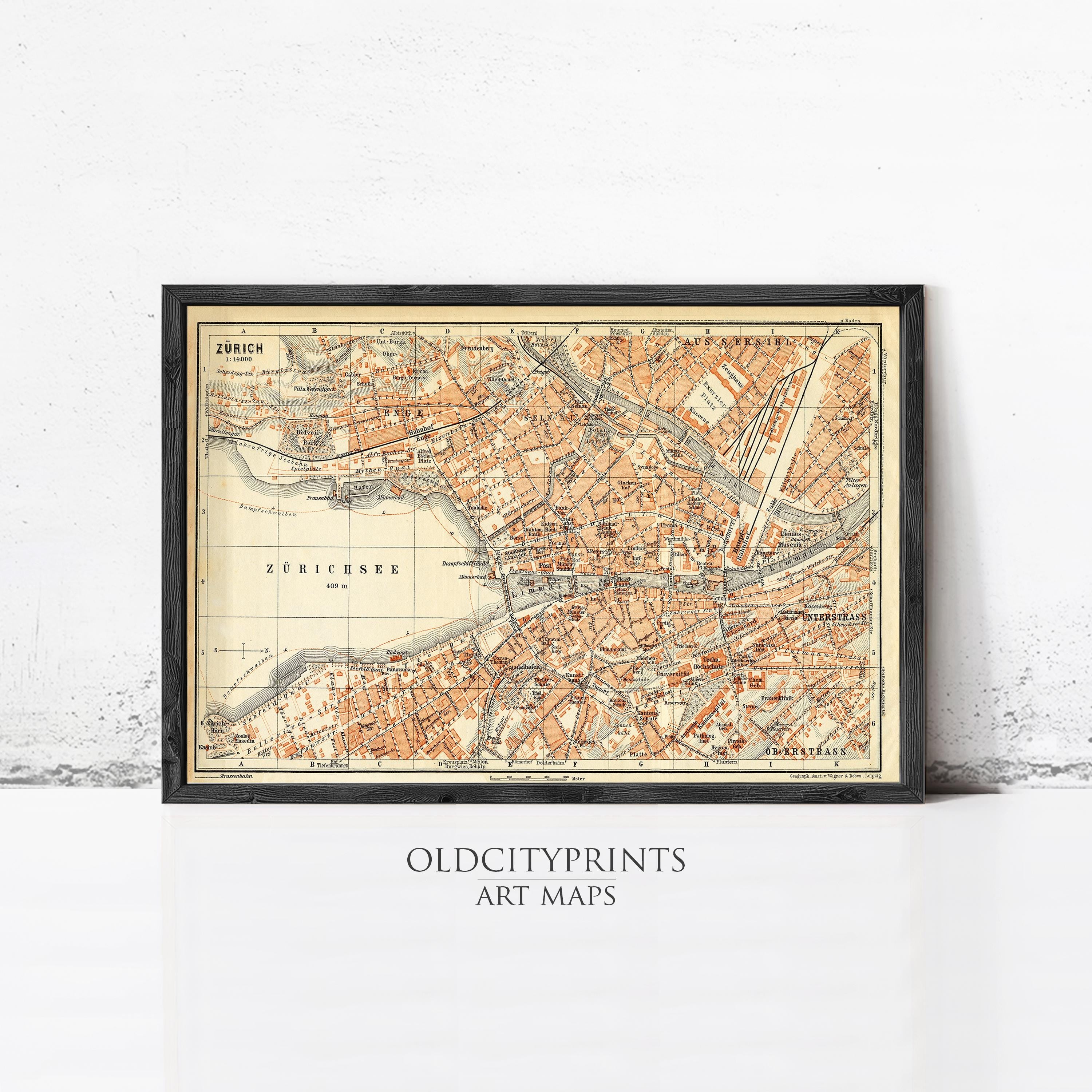 The image is a framed vintage map of a city, likely from the early 20th century, with a black border and a beige background.
