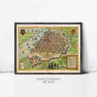 The image is a framed antique map of a city, depicting a detailed and intricate layout of the urban landscape.