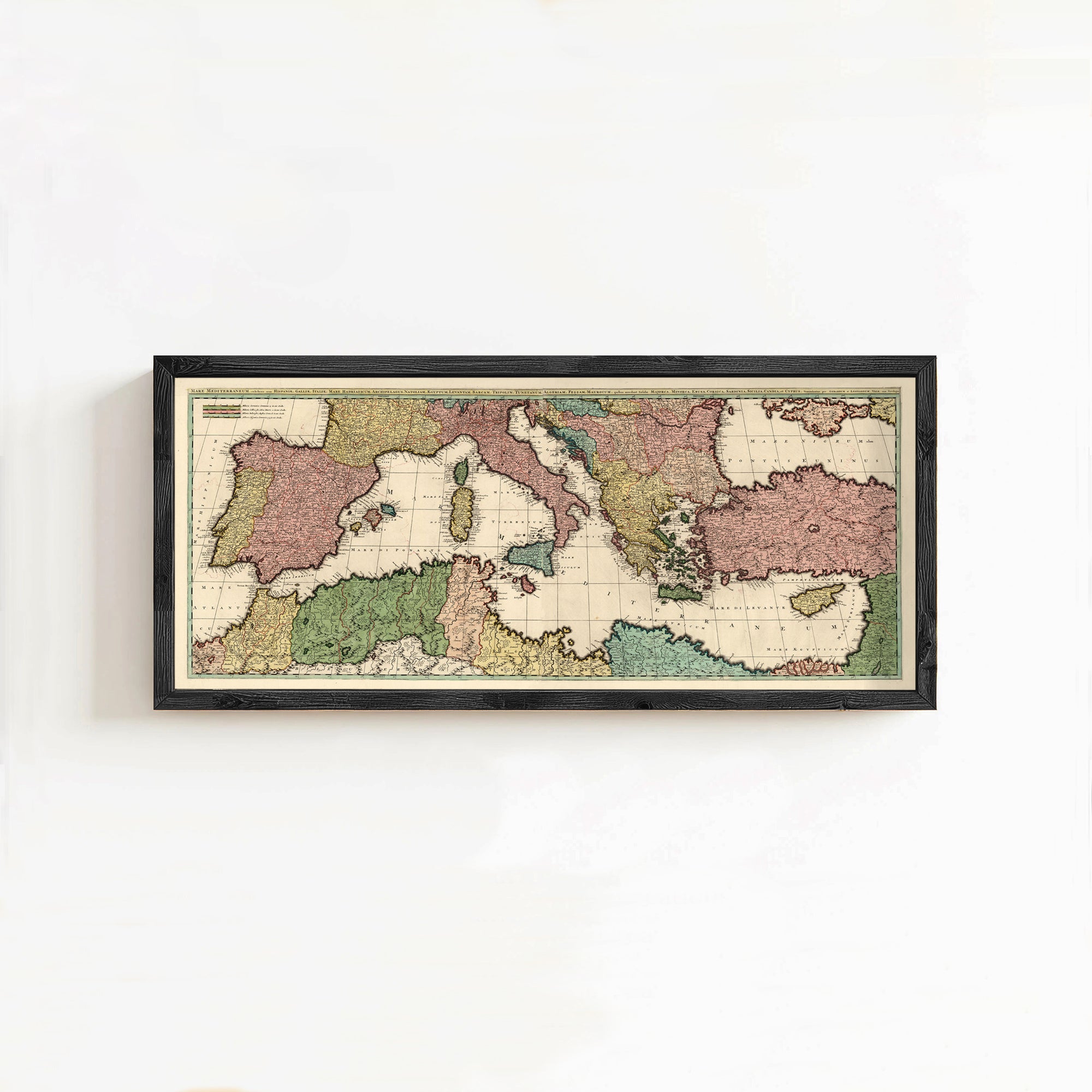 The image is a framed vintage map of Europe and the surrounding areas, displayed on a white wall.