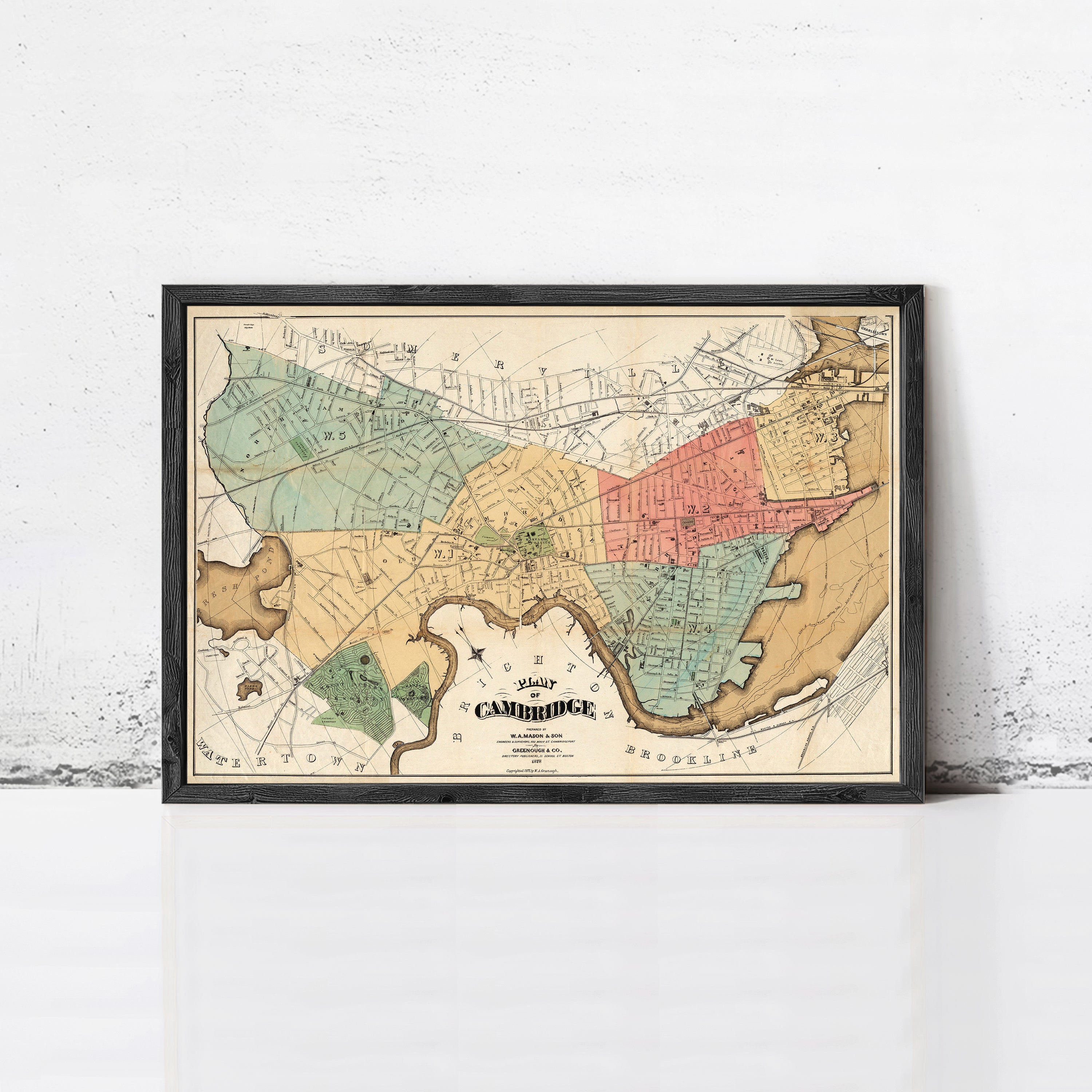 The image is a framed vintage map of Cambridge, Massachusetts, showing the city's streets and surrounding areas.