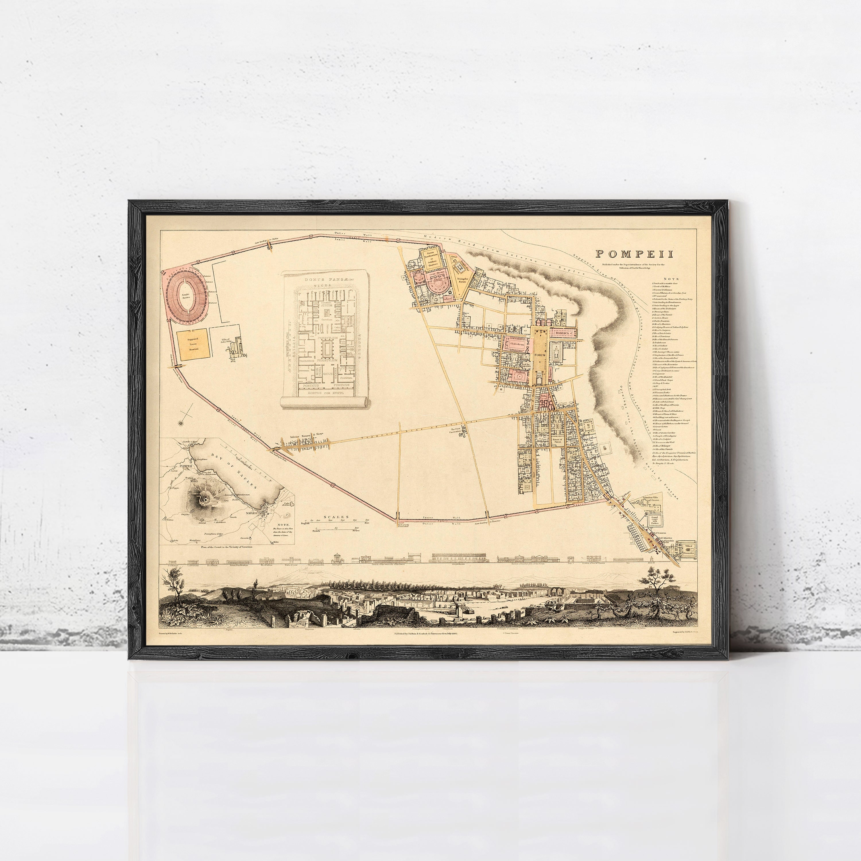 The image is a framed historical map of the city of Pompeii, depicting the city's layout and surrounding areas.