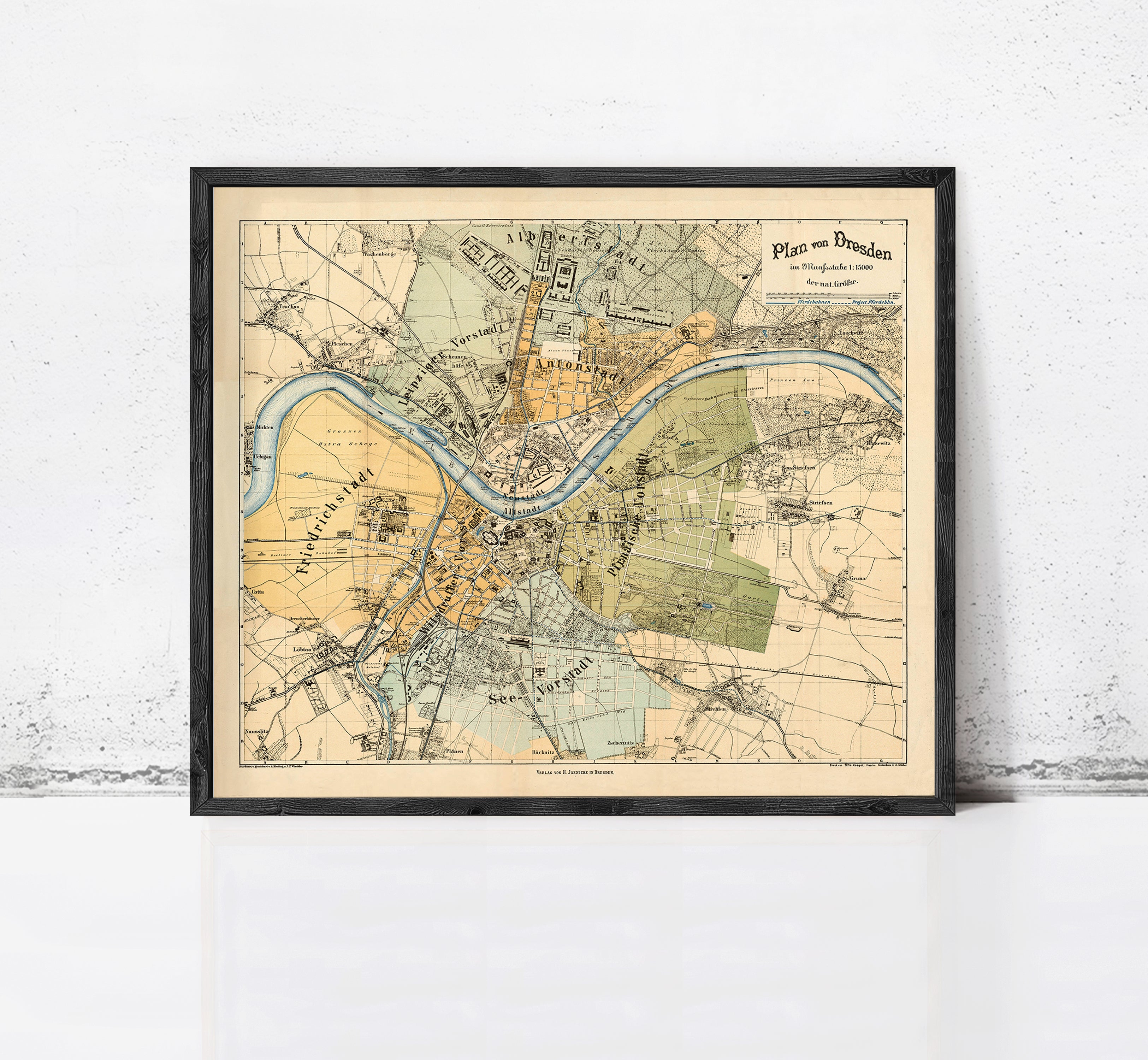 The image is a framed vintage map of a city, likely from the 19th century, depicting various landmarks and geographical features.