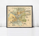 The image is a framed vintage map of a city, likely from the 19th century, depicting various landmarks and geographical features.