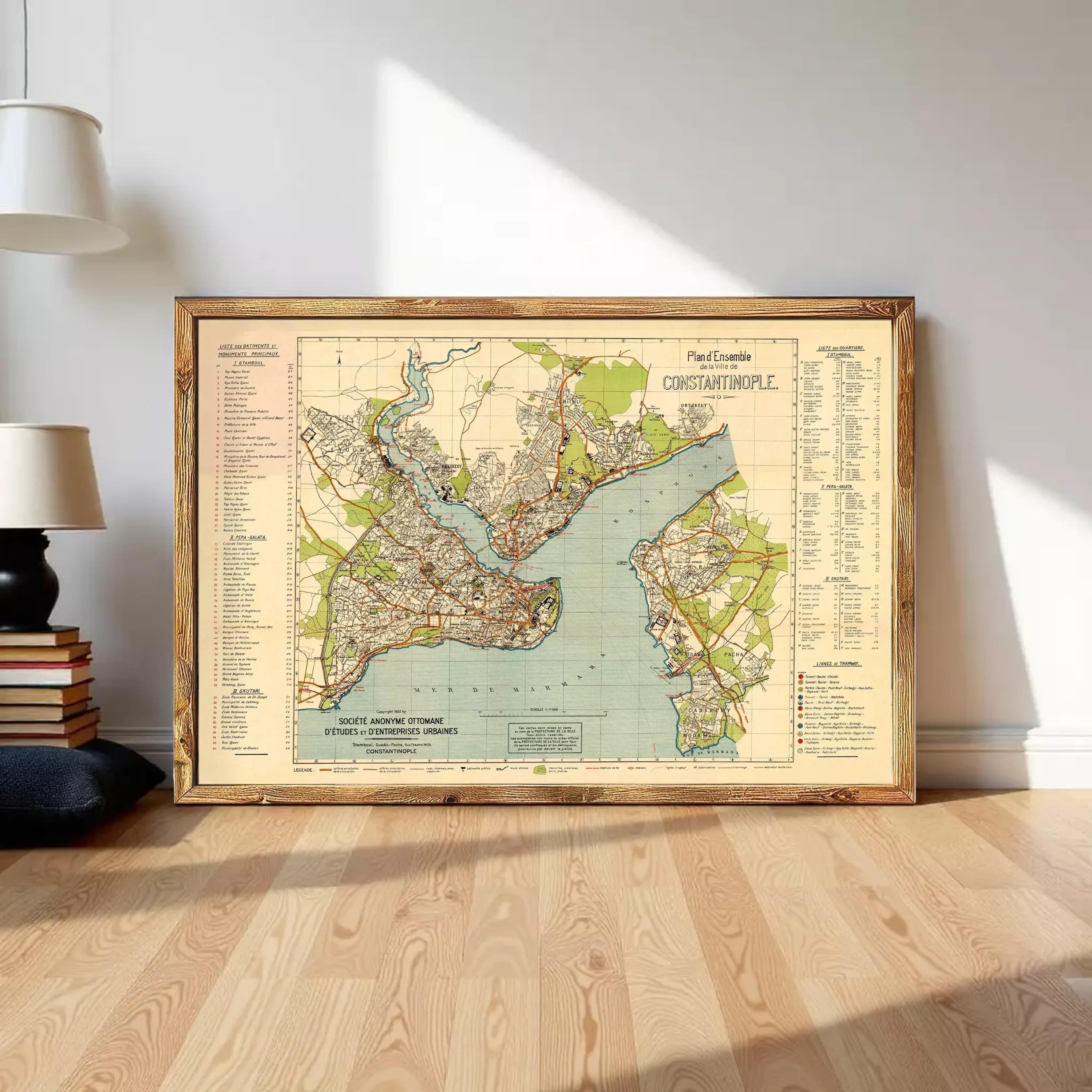 The image is a framed vintage map of a city, likely from the early 20th century, depicting a detailed layout of streets, landmarks, and waterways.
