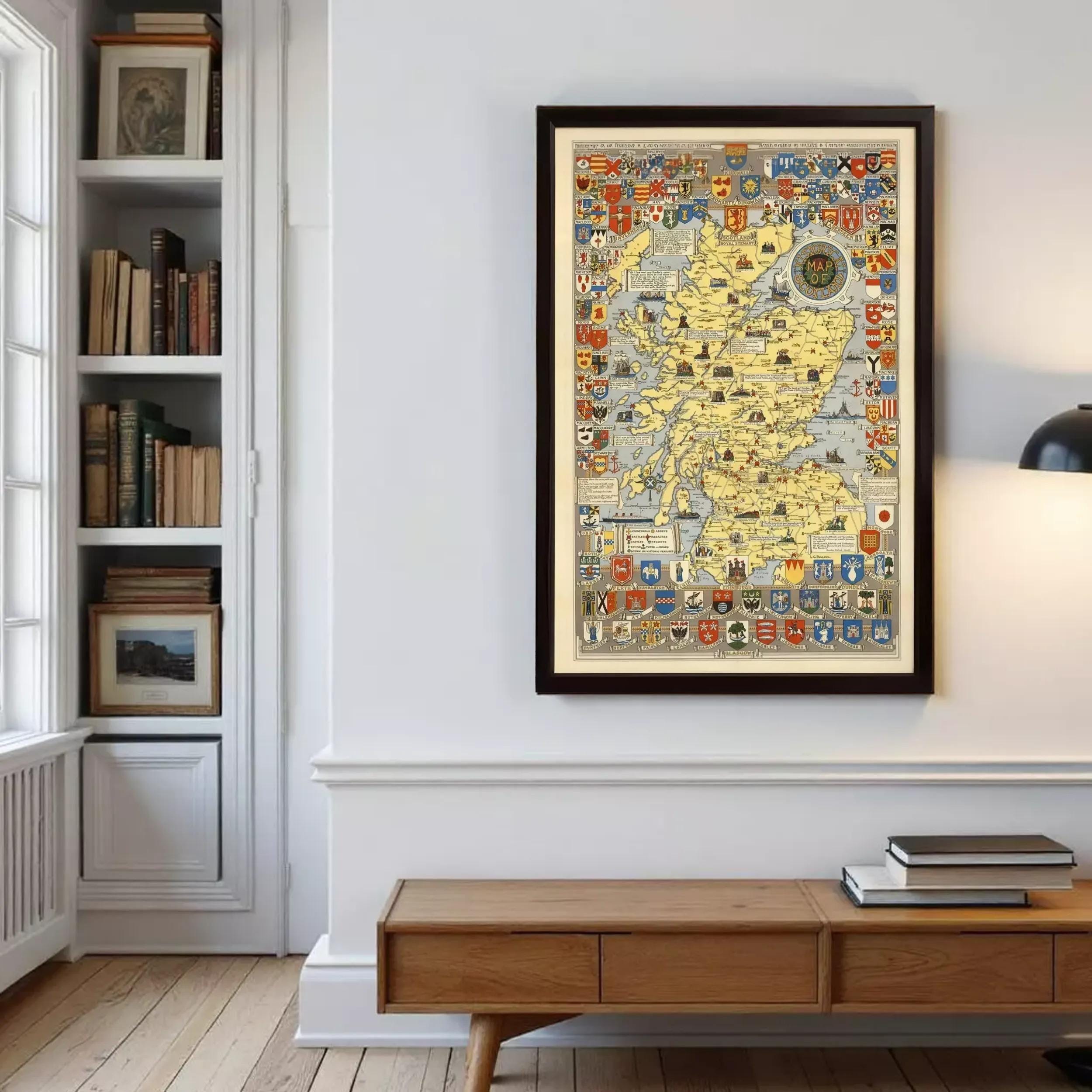 a large framed map of Scotland hanging on a wall in a room with a bookshelf and a wooden table.