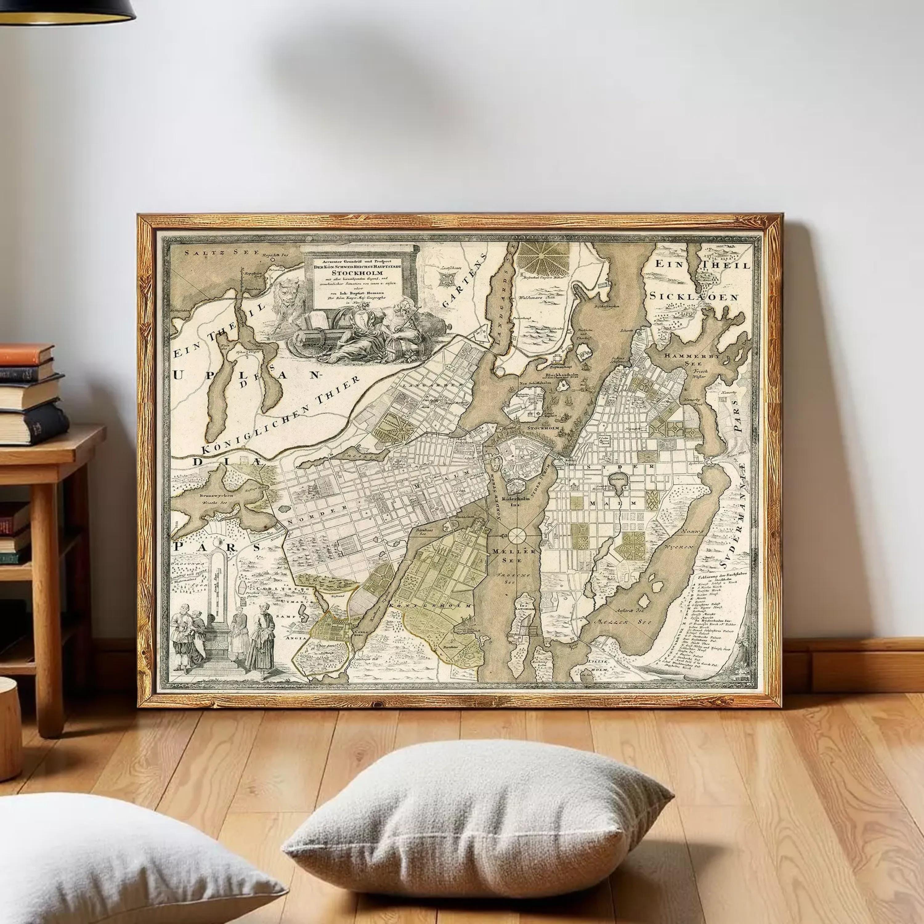 The image is a framed antique map of a city, likely from the 18th century, with detailed cartography and illustrations.