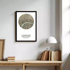 A framed map of London with a circular design in the center, depicting the city's streets and landmarks.