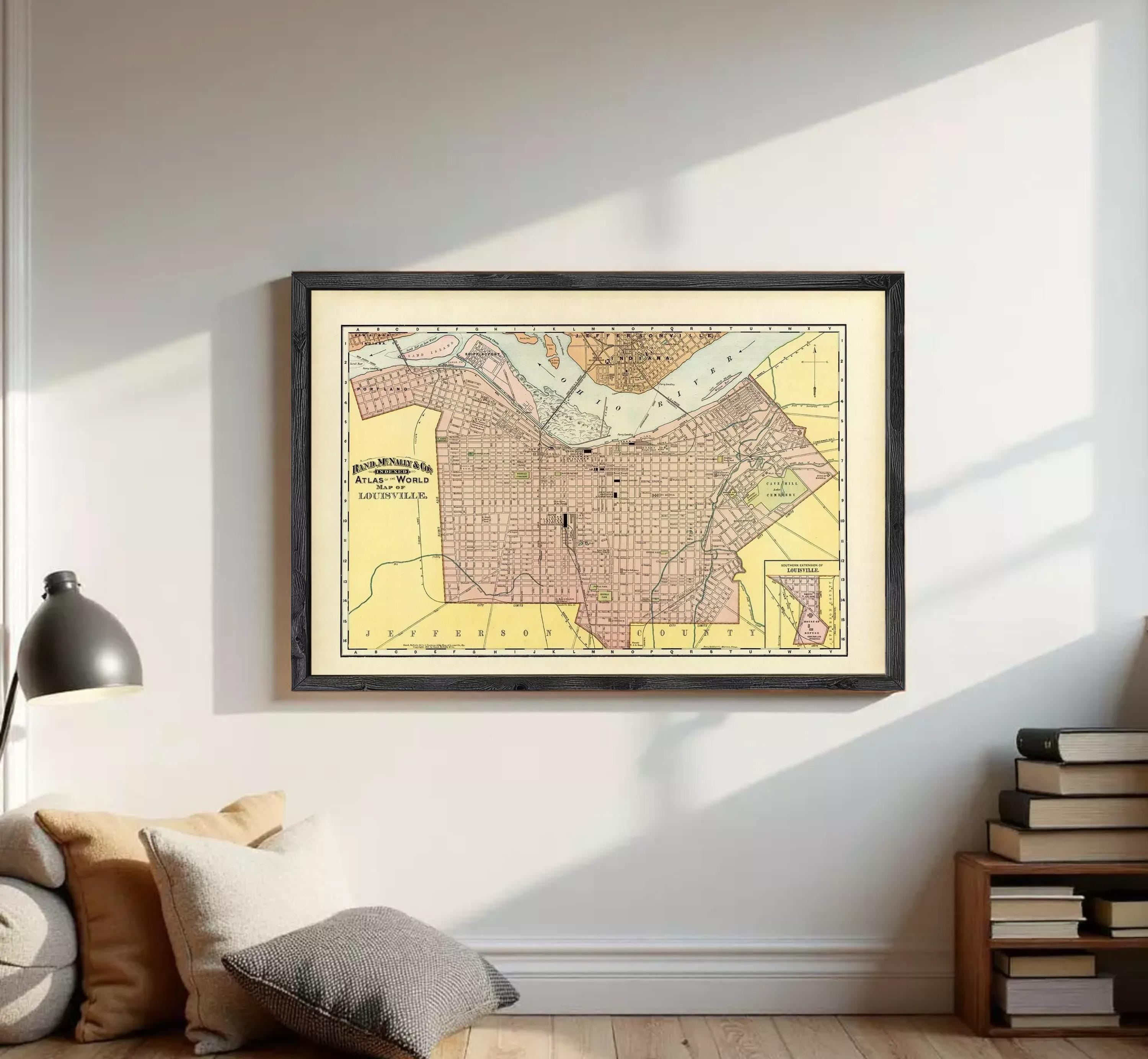 The image is a framed vintage map of a city, likely from the early 20th century, with a yellow and pink color scheme.