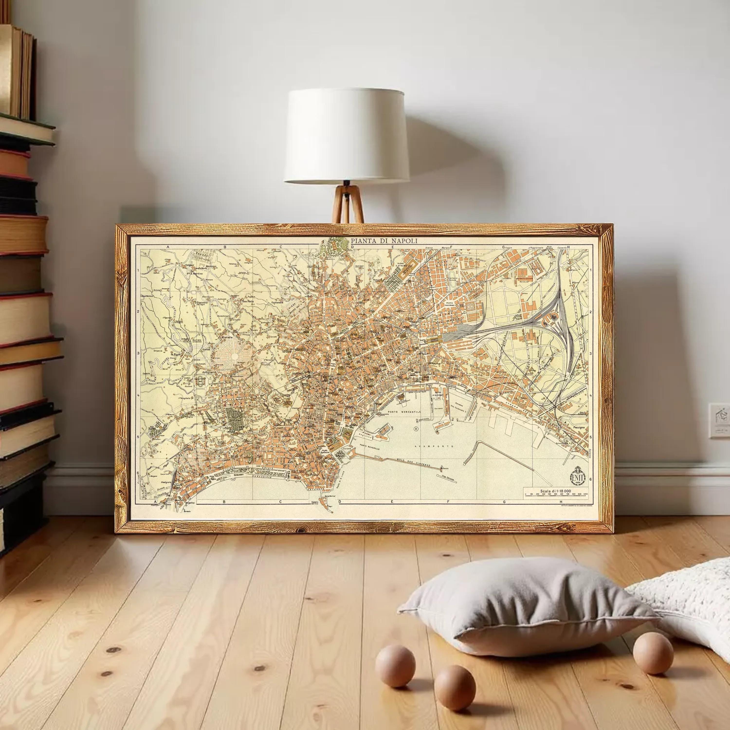 a large framed map of a city, with a lamp and some books in the background.