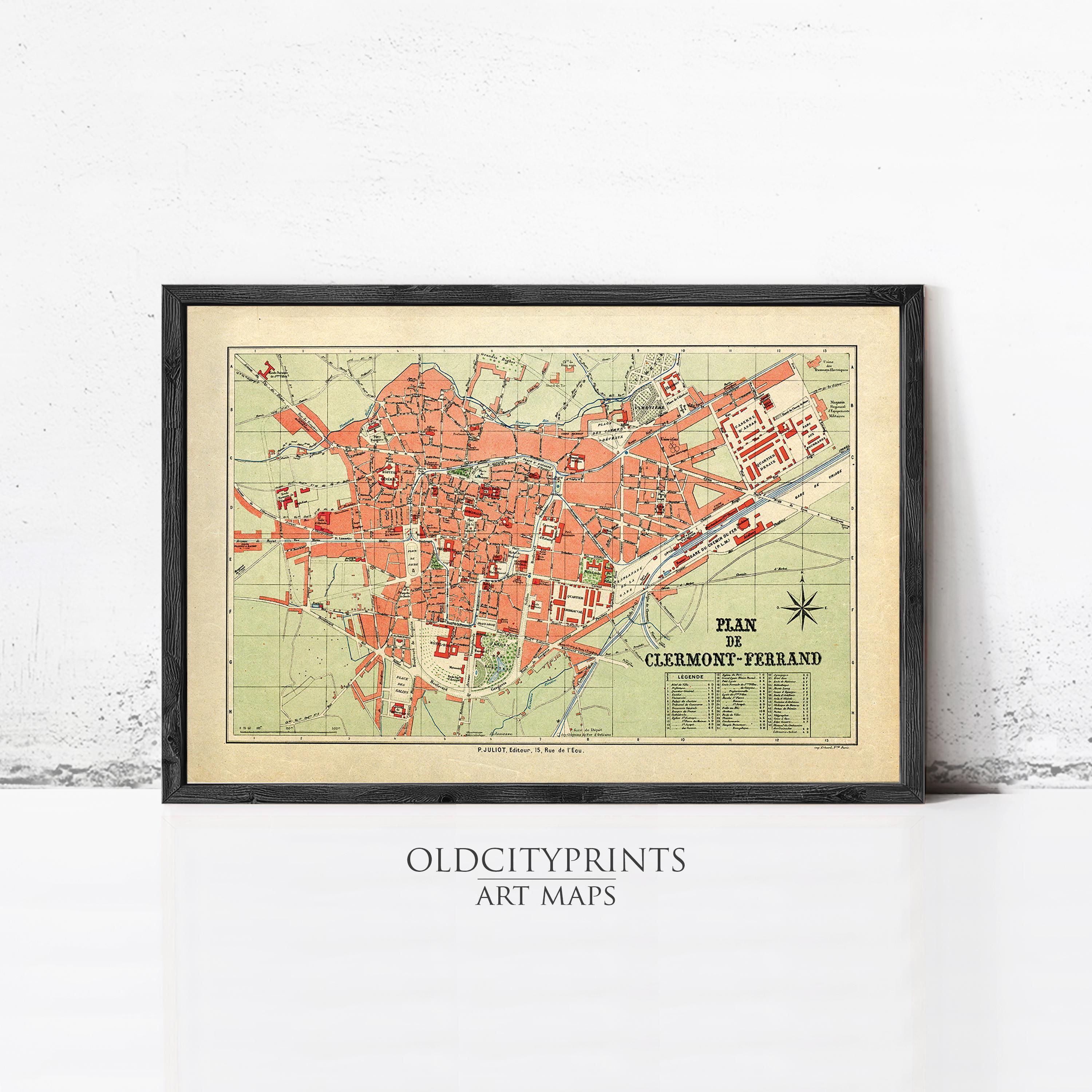 The image is a framed vintage map of a city, likely Clemont-Ferrand, with a black border and a green and orange color scheme.