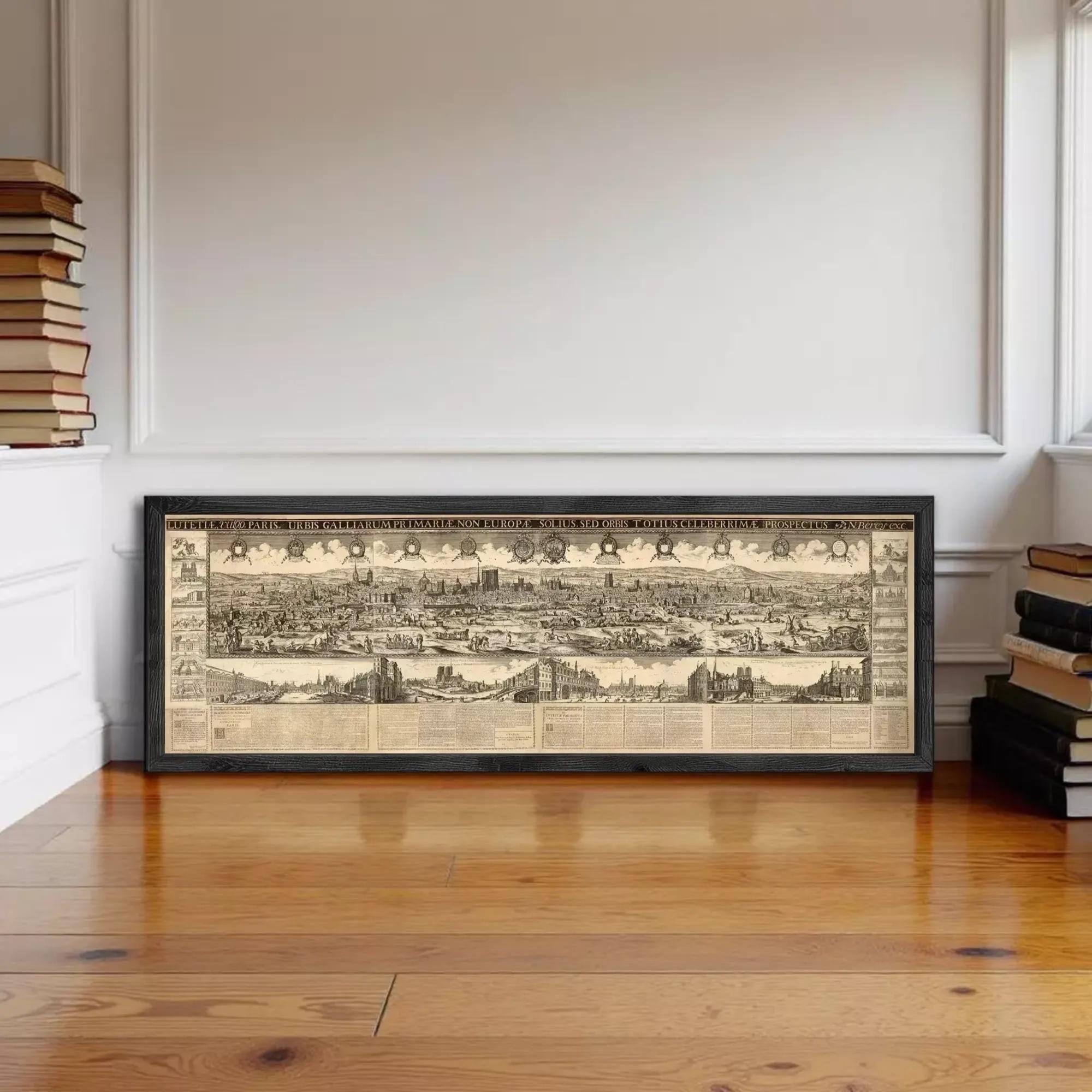 a large framed map of a city, with a detailed and intricate design, displayed on a wooden floor against a white wall.