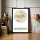 a framed map of the Virgin Islands, with a wooden stool and a lamp to the side.
