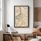 The image is a framed map of a city, likely from the 19th century, with a detailed layout of streets, rivers, and other geographic features.
