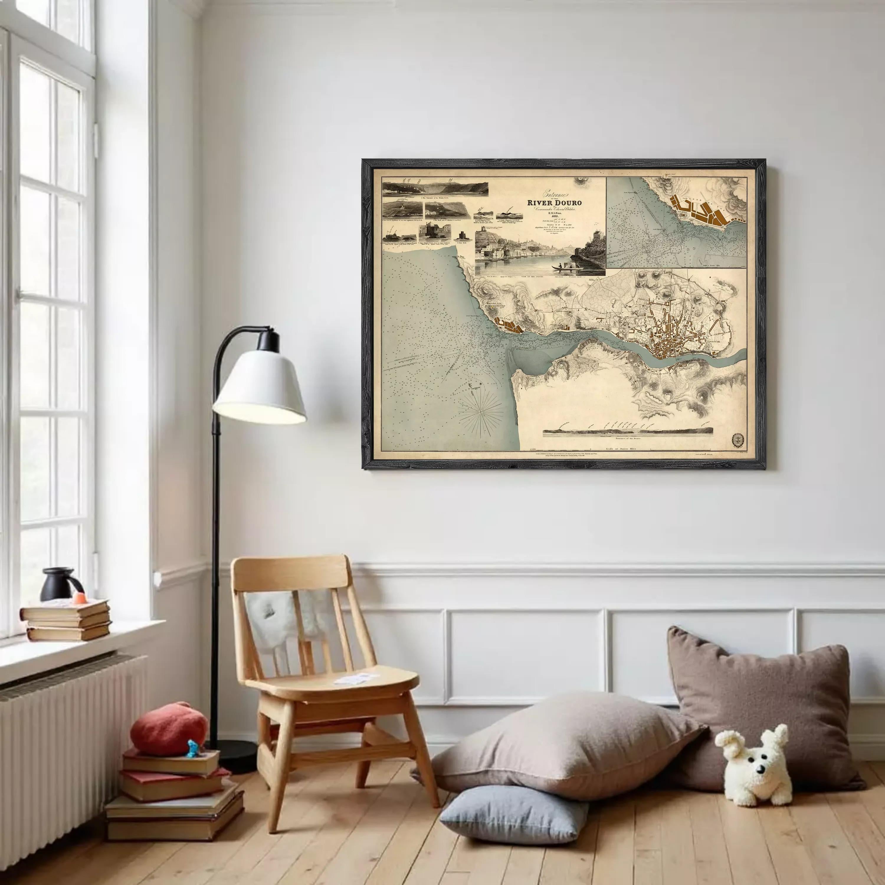 a cozy corner of a room with a wooden chair, a lamp, and a framed map hanging on the wall.