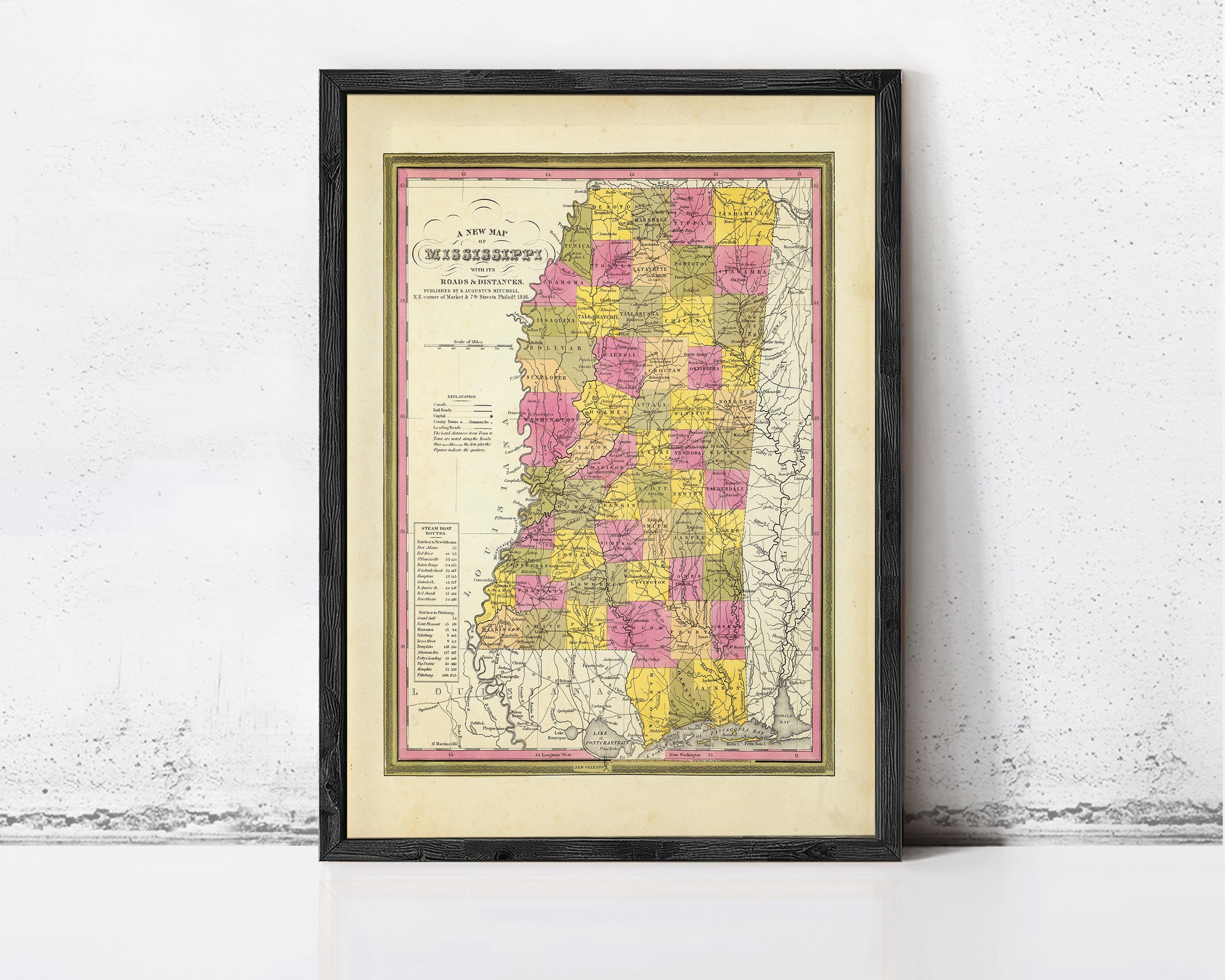A framed map of the state of Mississippi, with the state's borders clearly marked and the names of the cities and towns within the state.
