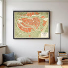 The image is a framed map of a city, likely from the 19th century, with a vintage style and a color palette of green, orange, and red.