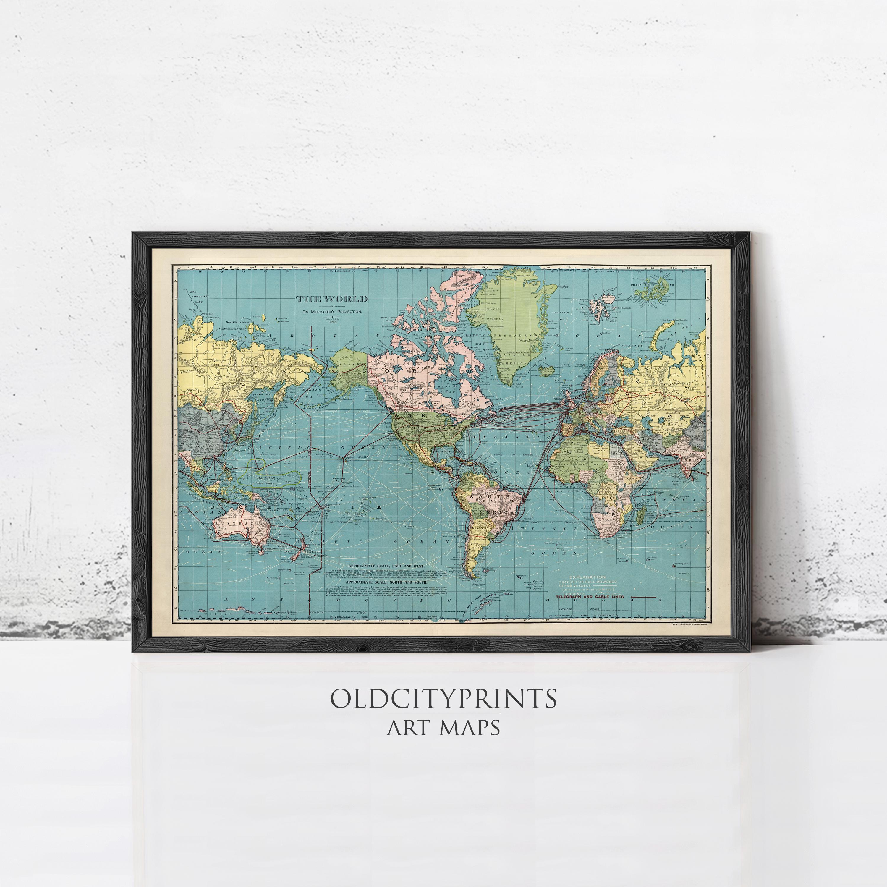 The image is a framed vintage world map from the early 20th century, depicting the continents and oceans in a colorful, detailed manner.