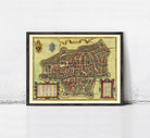 The image is a framed antique map of a city, likely from the Middle Ages, with intricate details and a decorative border.