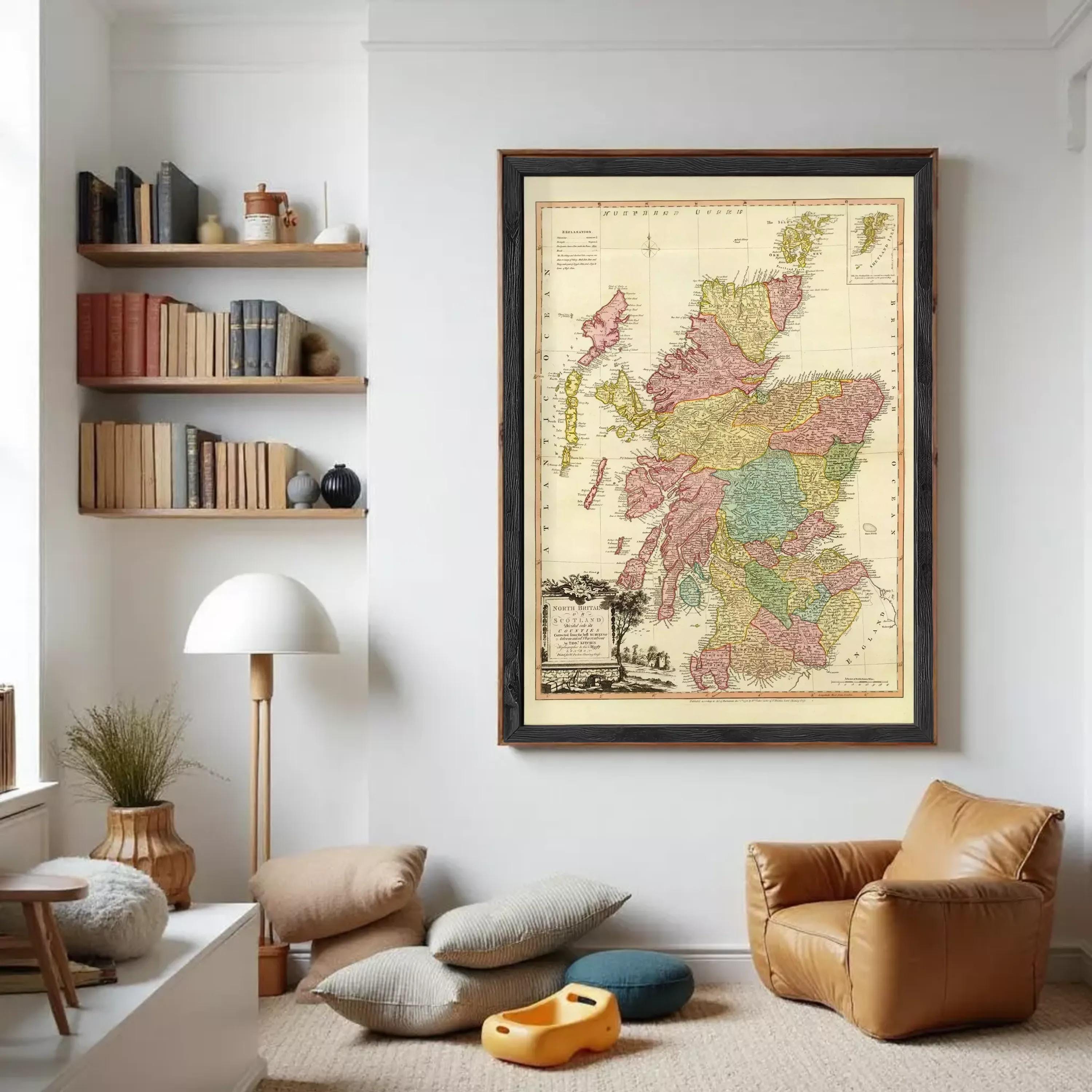 a large framed map of Scotland hanging on a white wall in a cozy living room setting.