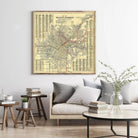 a large framed map of Los Angeles hanging on a wall, with a cozy living room setting below it.