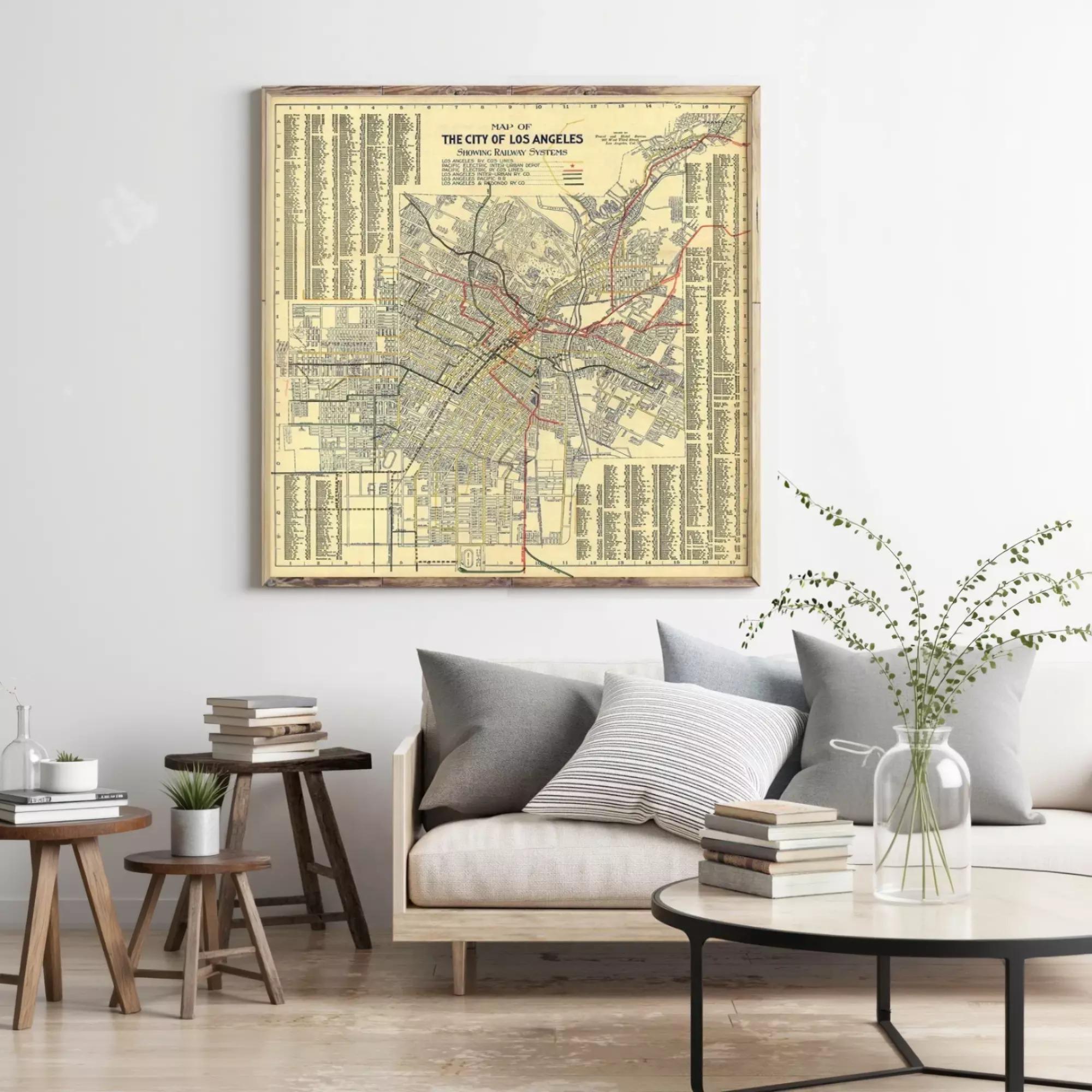 a large framed map of Los Angeles hanging on a wall, with a cozy living room setting below it.