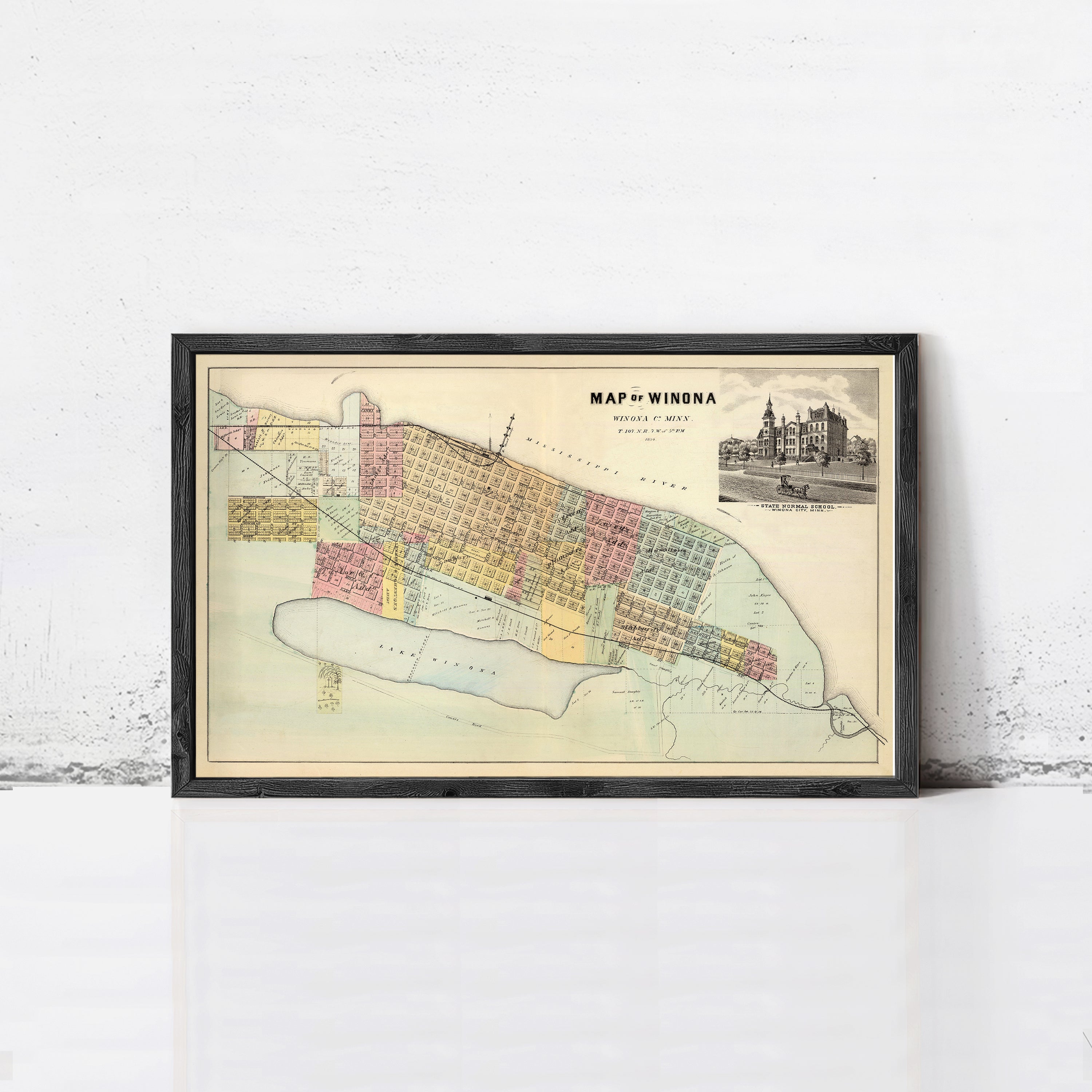 The image is a framed vintage map of Winona, Minnesota, depicting the city's layout and surrounding areas.