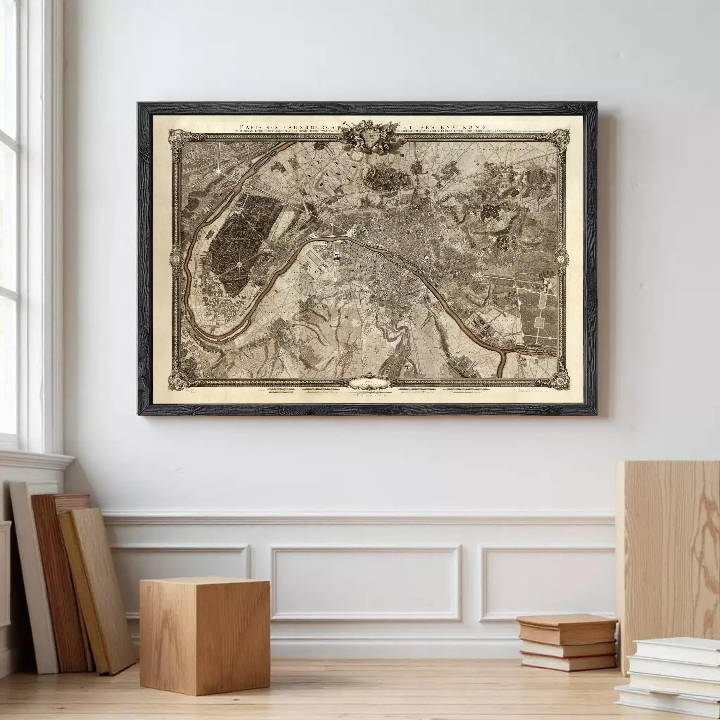 a large framed map of Paris, France, hanging on a wall in a room with a wooden floor.