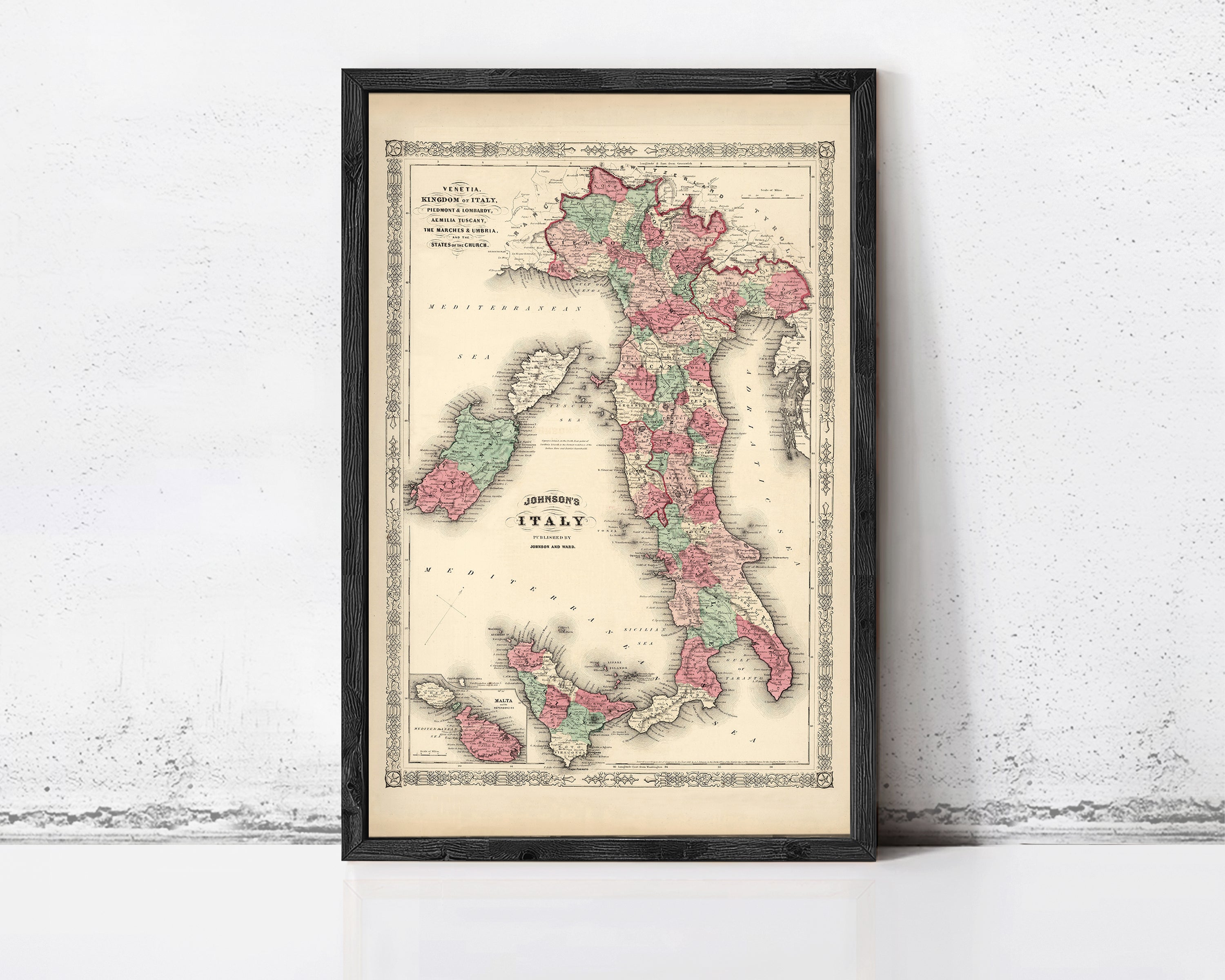 A framed vintage map of Italy, depicting the country in a detailed and colorful manner.