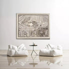 a large framed map of a city hanging on a white wall, with two white bean bag chairs positioned in front of it.