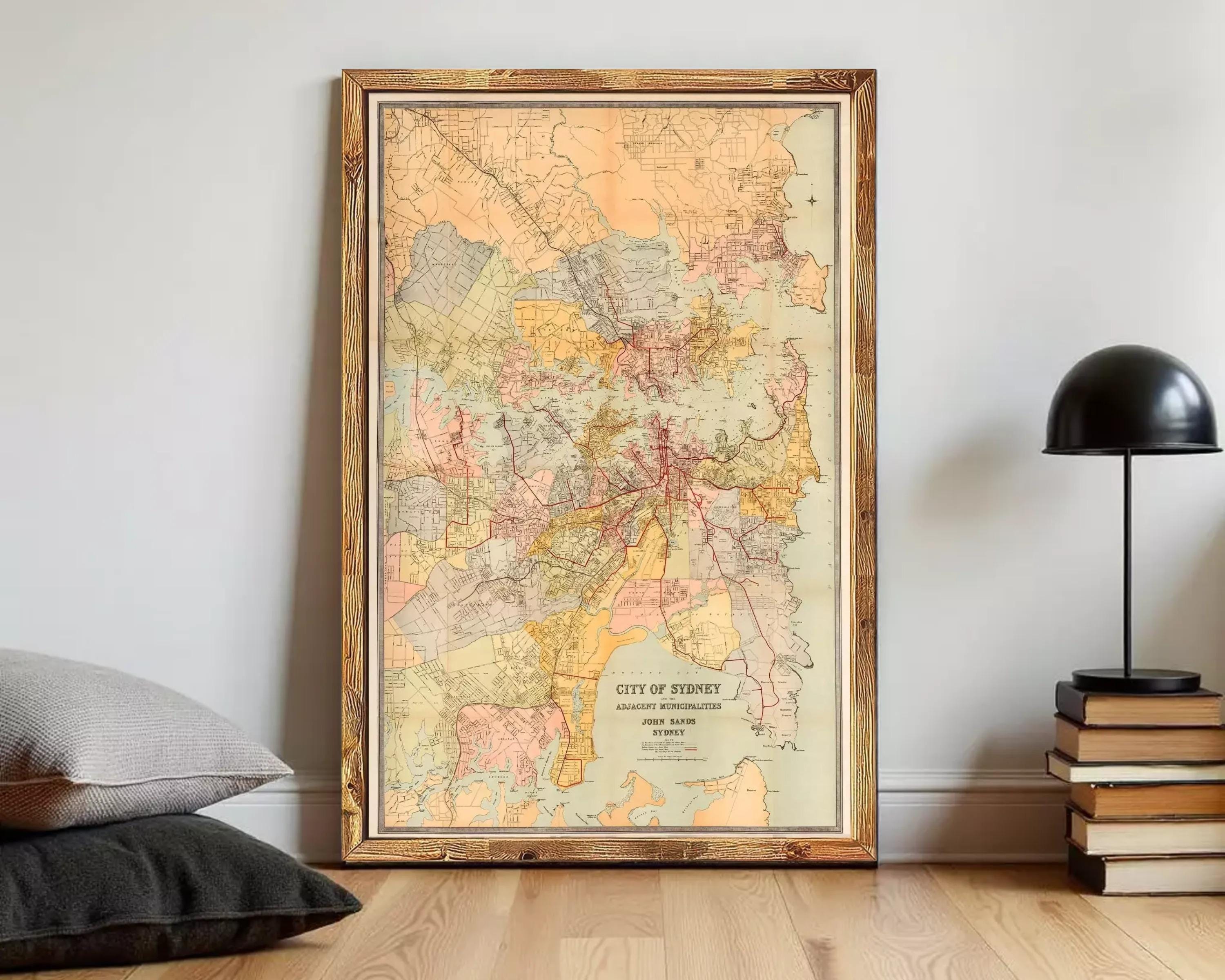 The image is a framed vintage map of the city of Sydney, Australia, depicting the city's streets and surrounding areas.