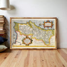 The image is a framed antique map of a region, possibly a coastal area, with intricate details and a decorative border.