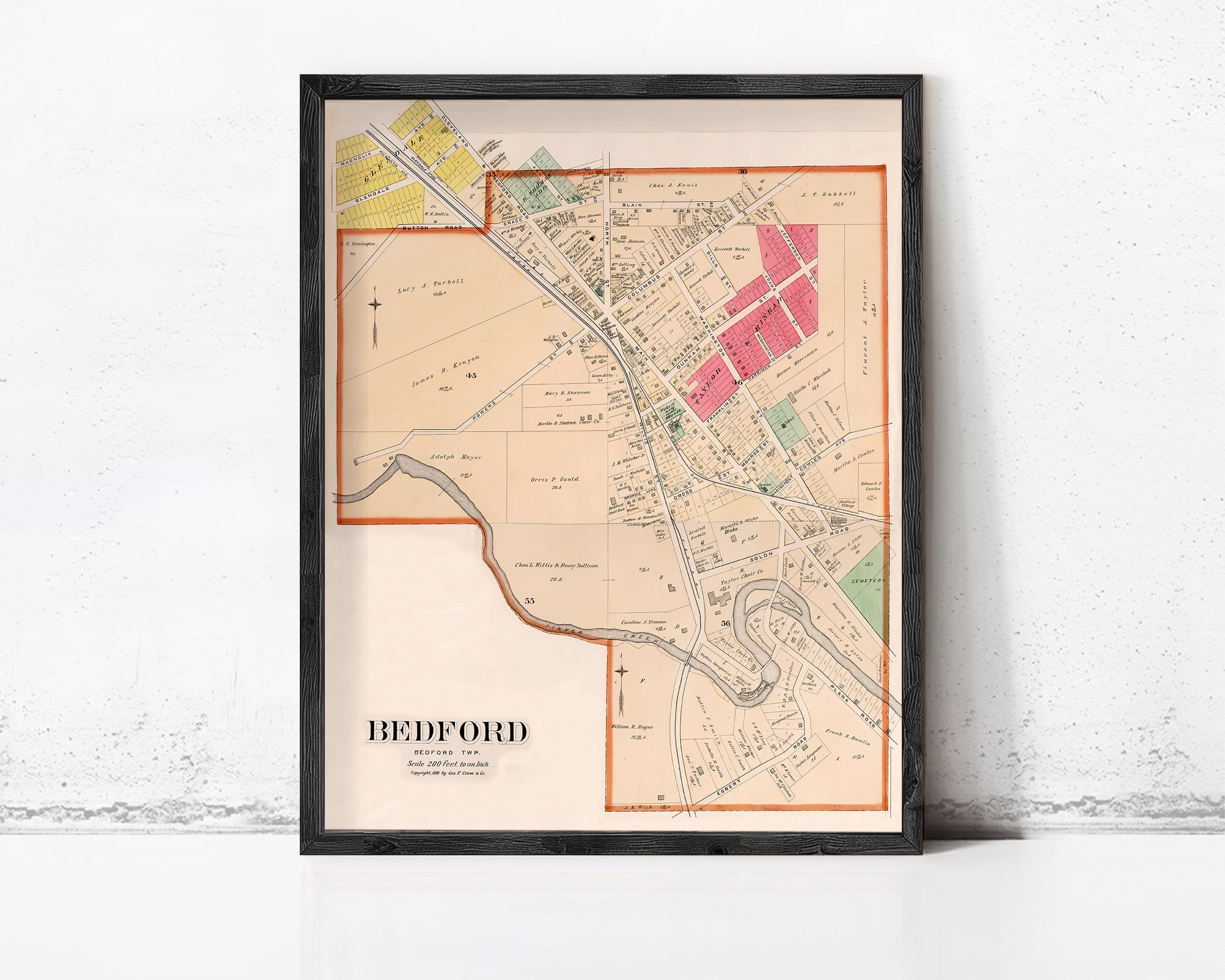 A framed map of Bedford, New Jersey, with various colored areas and streets labeled.