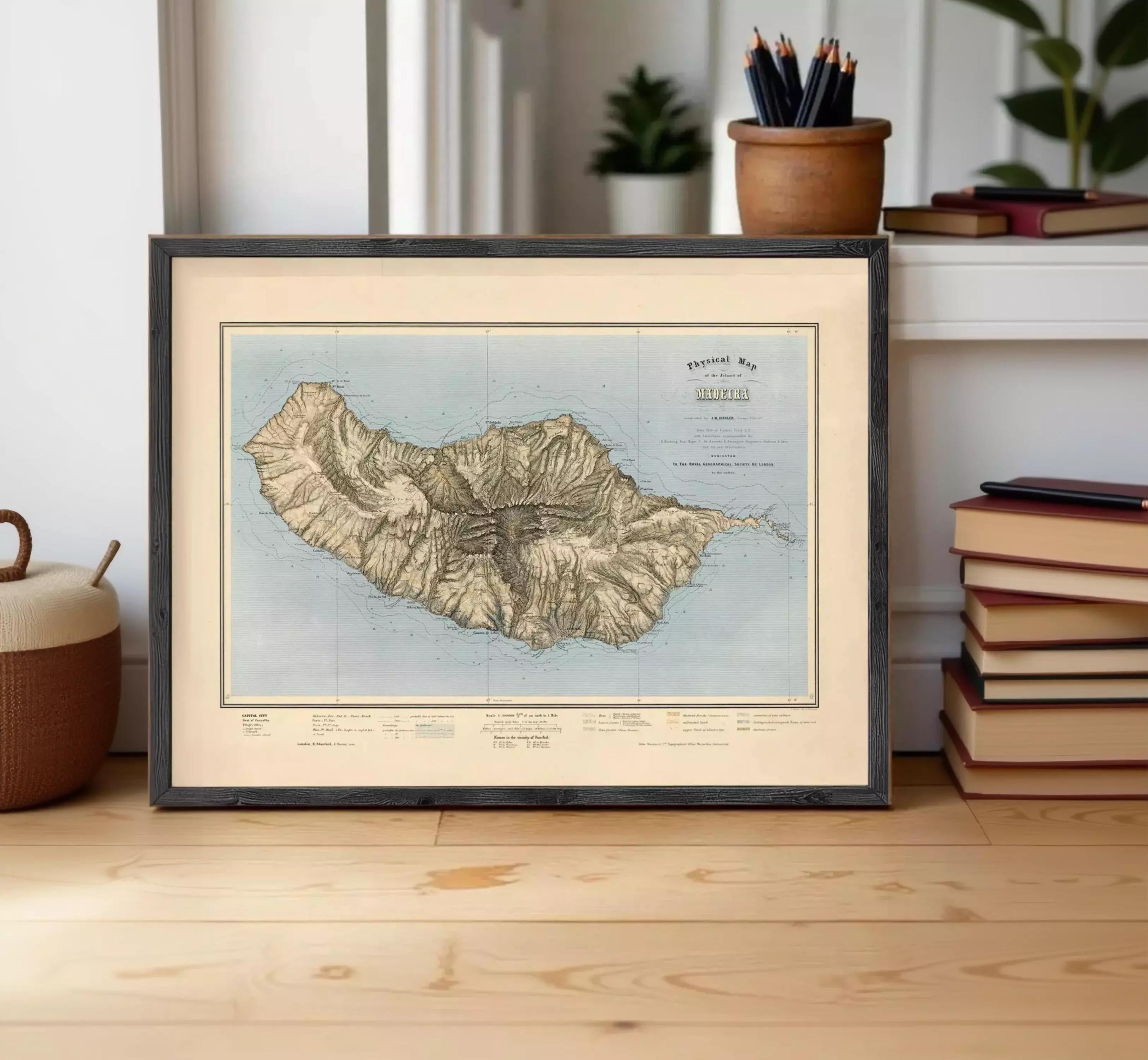a framed map of the island of Tenerife, Spain, displayed on a wooden surface.