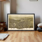 a framed map of Scranton, Pennsylvania, with a wooden floor and a stack of books in the background.