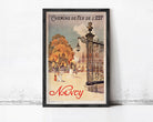 A framed vintage poster advertising Nancy, featuring an illustration of a park scene with people and a gazebo.