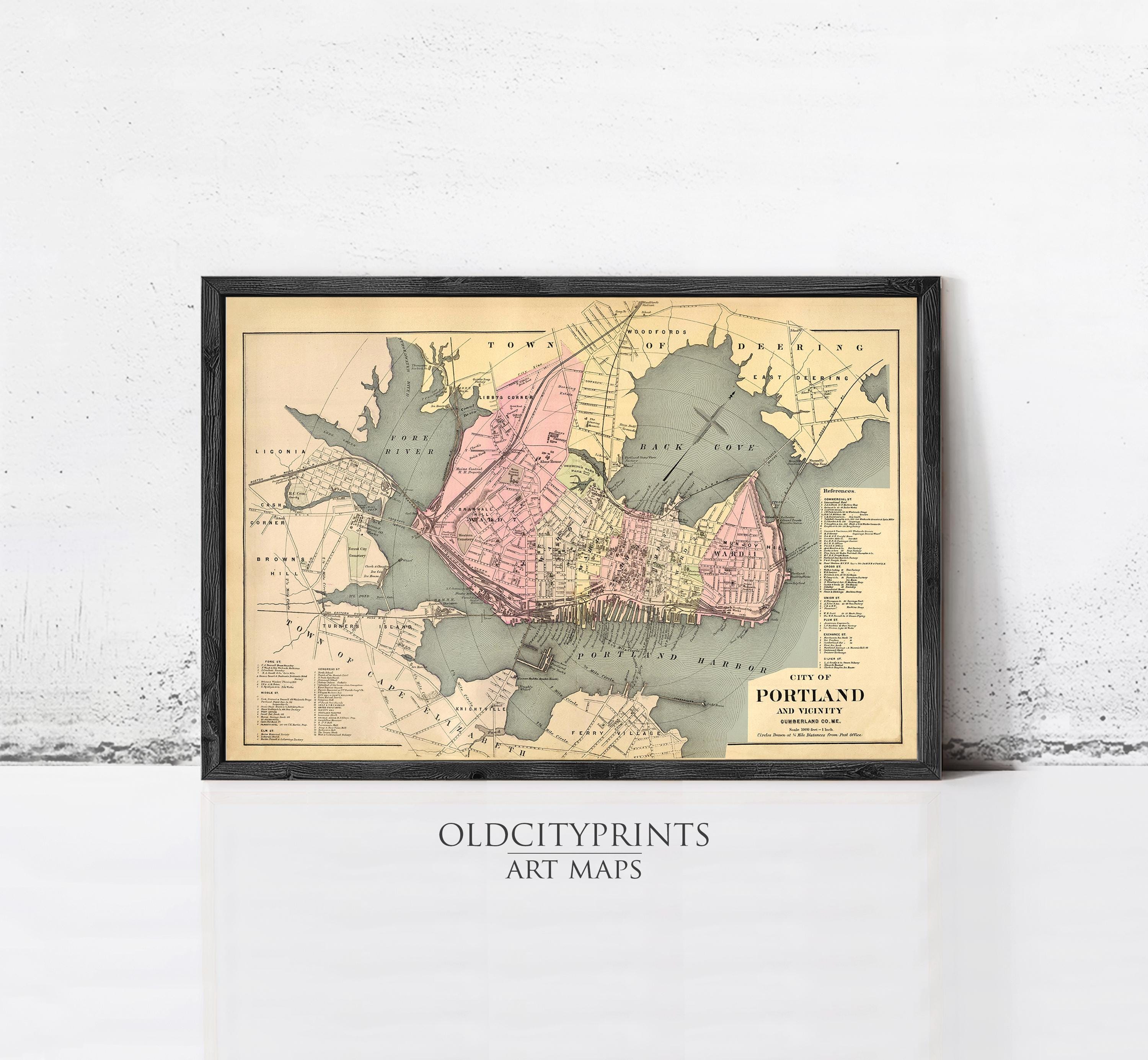 The image is a framed vintage map of Portland, Oregon, depicting the city's layout and surrounding areas.