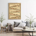 a cozy living room with a large framed vintage map hanging on the wall, a comfortable couch with pillows, a coffee table with books and a vase of greenery, and a few potted plants.