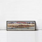 A framed painting depicting a cityscape with boats and ships in the water, set against a cloudy sky.