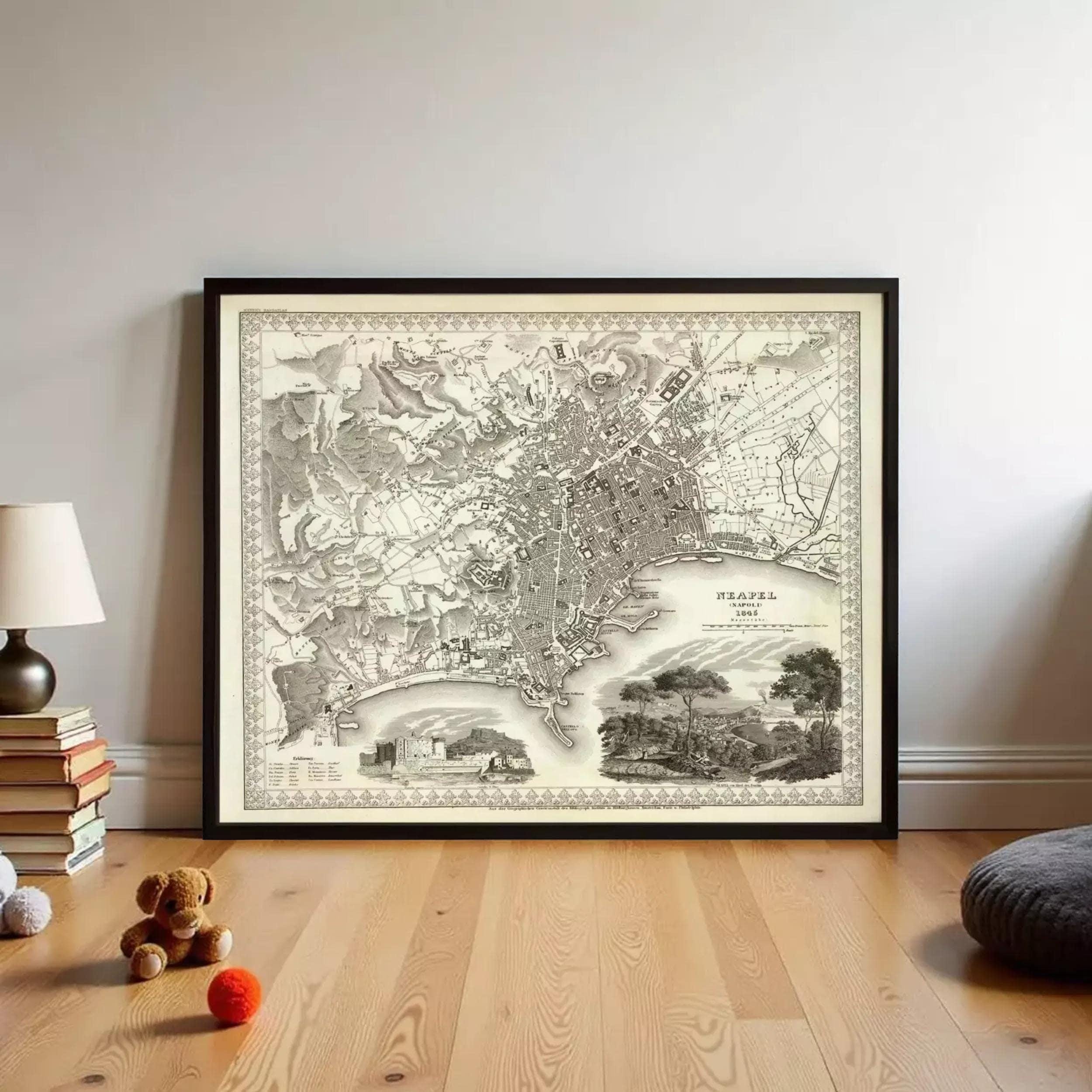 a large framed map of a city, with various landmarks and streets depicted. The map is placed on a wooden floor, and there are some books and a teddy bear nearby.
