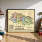 The image is a framed vintage map of a region, likely depicting a country or region, with various colored regions and a silhouette of a mountain range.