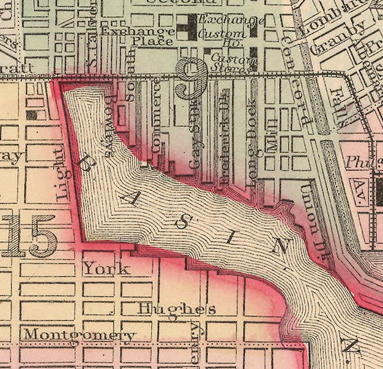 The image is a historical map of a city, showing streets, landmarks, and a river or bay.