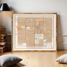 The image is a framed map of Regina, Canada, with a vintage style and a wooden frame.