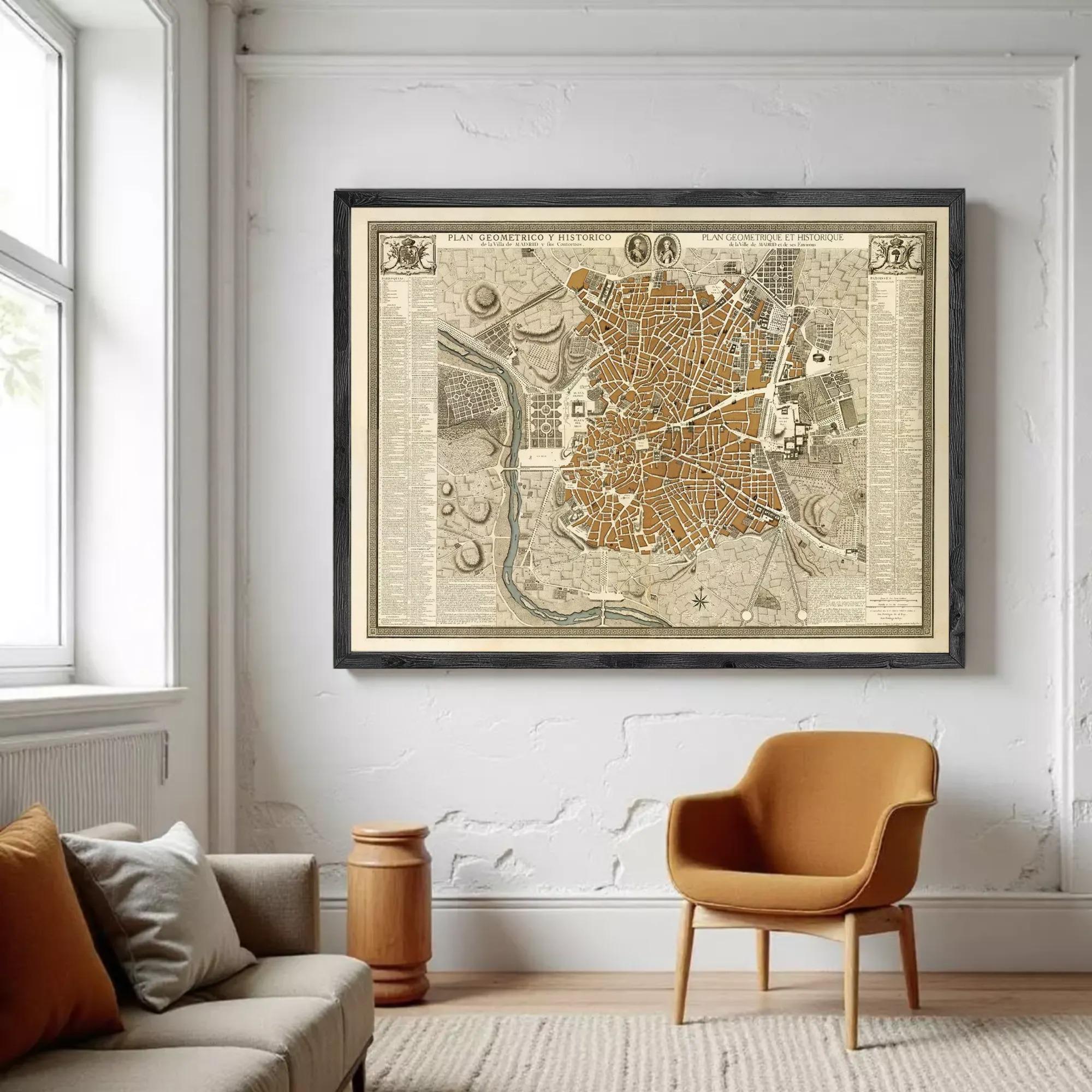 a large framed map of a city hanging on a white wall in a living room.