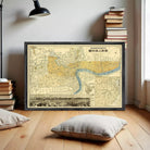 The image is a framed vintage map of London, England, with a black border and yellow and blue color scheme.